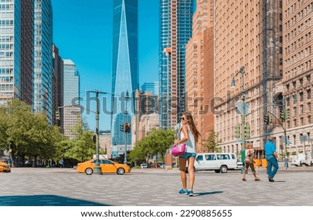 New York city life. Woman walking by view of Manhattan skyline American people walking enjoying Manhattan on perfect summer day. NYC cityscape