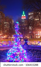 New York City Madison Square Park View With Christmas Decoration Lights And Empire State Building.