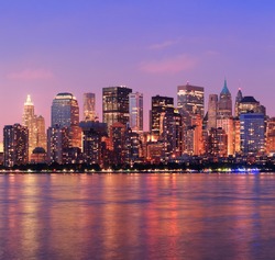 New York City Manhattan Downtown Skyline At Dusk With Skyscrapers Illuminated Over Hudson River Panorama
