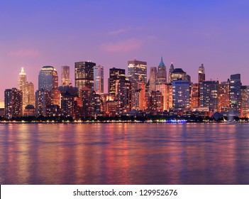 New York City Manhattan Downtown Skyline At Dusk With Skyscrapers Illuminated Over Hudson River Panorama