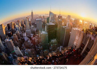 New York City. Manhattan downtown skyline with illuminated Empire State Building and skyscrapers at sunset. Vertical composition Fish eye lens shot.