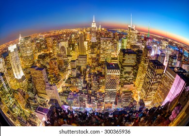 New York City. Manhattan downtown skyline with illuminated Empire State Building and skyscrapers at dusk seen from observation deck. Panoramic fish eye view.