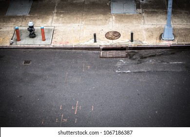 New York City, Manhattan Street Scene Viewed From Above With Sidewalk, Fire Hydrant And Manhole Drainage Seen From Chelsea.