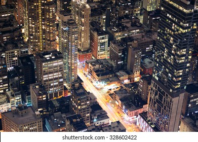 New York City Manhattan Street Aerial View At Night With Skyscrapers, Pedestrian And Busy Traffic.