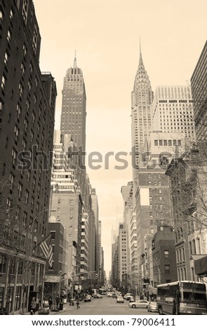 New York City Manhattan street view with Chrysler Building skyscrapers and busy traffic black and white.