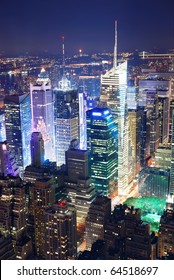 New York City Manhattan Times Square Panorama Aerial View At Night With Office Building Skyscrapers Skyline Illuminated By Hudson River.