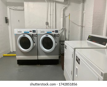 New York City, New York - May 2020: Resident Does Laundry In Basement Of Coop Apartment