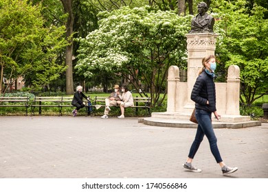 NEW YORK CITY - MAY 24, 2020:  View From Historic Washington Square Park In Manhattan During The Covid-19 Coronavirus Pandemic With People Wearing Protective Masks Visible 