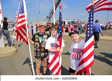 NEW YORK CITY - MAY 25 2016: Ships Of The US Navy Docked In The Brooklyn Ferry Terminal As The 28th Annual Fleet Week Started. Members Of Little Patriots Greet Returning Service Members