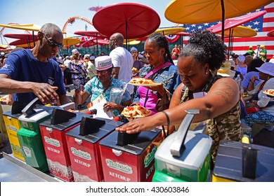 NEW YORK CITY - MAY 28 2016: Coney Island's Landmark Establishment Nathan's Famous Celebrated Its Centennial Anniversary With 5 Cent Hot Dogs. Applying Condiments At Station