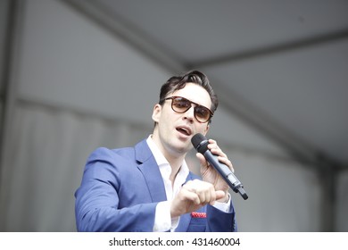 NEW YORK CITY - MAY 30 2016: Green-Wood Cemetery staged it's 28th annual Memorial Day concert by the Symphonic Orchestra at 3rd Street. Broadway singer Ryan Silverman sings Leonard Bernstein