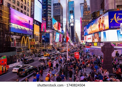 NEW YORK CITY - MAY 9, 2019: Times Square crowds and traffic on a rainy night. The site is regarded as the world's most visited tourist attraction with nearly 40 million visitors annually.