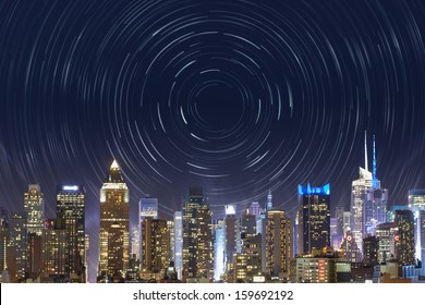new york city, midtown manhattan, view from the outside to the bright time square, with a star trails effect in the night sky, for a time concept, bound to this famous place