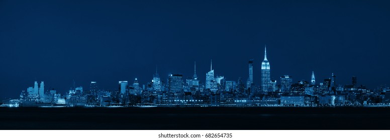 New York City midtown skyline with skyscrapers over Hudson River viewed from New Jersey at night - Shutterstock ID 682654735
