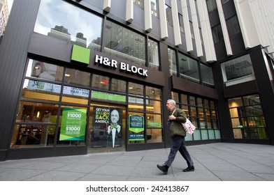 NEW YORK CITY - MONDAY, DEC. 29, 2014: Pedestrians Walk Past An Office Of H&R Block. H&R Block Is A Tax Preparation Company In The United States
