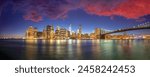 New York City night lights. Lower Manhattan and Brooklyn Bridge panorama from Brooklyn Bridge Park.