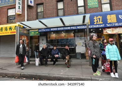 NEW YORK CITY - NOV 12: People Wait At A Busstop On A Street In A Brooklyn Chinatown On Nov 12, 2015 In New York City, USA.