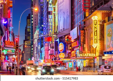 NEW YORK CITY - NOVEMBER 14, 2016: Traffic Moves Below The Illuminated Signs Of 42nd Street. The Landmark Street Is Home To Numerous Theaters, Stores, Hotels, Restaurants, And Attractions.