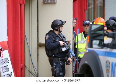 NEW YORK CITY - NOVEMBER 22 2015: Emergency response personnel staged an active shooter exercise in Manhattan's Lower East Side. Counter terrorism officer in tactical gear with fake assault rifle - Shutterstock ID 342864677