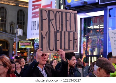 New York City - November 8, 2018: People holding signs at a rally in Time's Square supporting Robert Mueller and the Russia investigation after the firing of Attorney General Jeff Sessions.