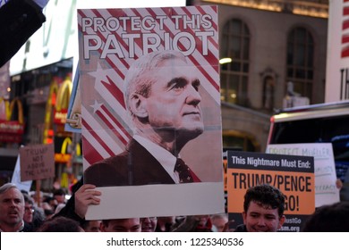 New York City - November 8, 2018: People holding signs at a rally in Time's Square supporting Robert Mueller and the Russia investigation after the firing of Attorney General Jeff Sessions.