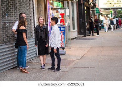 New York City, NY, May  27, 2017: Friends Hang Out In Greenwich Village In Manhattan. Greenwich Village Has A Vibrant Nightlife And Attracts Many People To Its Bars, Restaurants And Comedy Clubs.