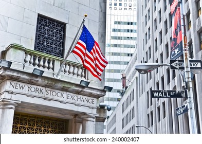 NEW YORK CITY, NY - OCT 11: The side entrance of New York Stock Exchange and a street sign of Wall Street shown on October 11, 2013 in New York City. The Exchange building was built in 1903.