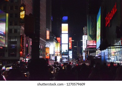 New York City, NY, USA - 121217:
A Colourful, Vibrant View Of The Times Square / Broadway Region Of New York City At Night. Bright Bill Boards Light Dark, Busy Streets