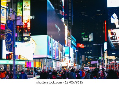 New York City, NY, USA - 121217:
A Colourful, Vibrant View Of The Times Square / Broadway Region Of New York City At Night. Bright Bill Boards Light Dark, Busy Streets