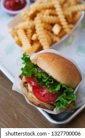 New York City, NY, USA - Sept 11 2012: Angus Beef Cheeseburger With Lettuce And Tomatoes And Fries At Fast Food Chain Restaurant Shake Shack At Its Upper West Side Location In Manhattan