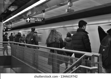 New York City, NY/ USA: 3-14-19: Commuters Waiting For Subway Train New York City MTA Station