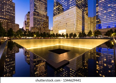 New York City, NY, USA - October 10, 2017: The North Reflecting Pool illuminated at twilight with view of One World Trade Center. Lower Manhattan, 9/11 Memorial & Museum