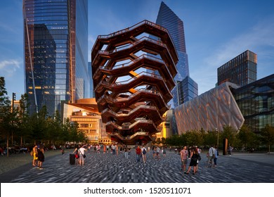 New York City, NY, USA - July 1, 2019:  Hudson Yards esplanade with The Vessel (staircase) and the Shed at sunset in summer. Midtown West, Manhattan