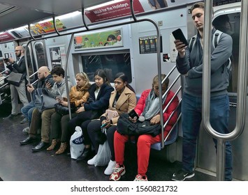 New York City, NY/ USA- 11-04-19: NYC Subway Car People Looking At Cell Phones Riding The Train