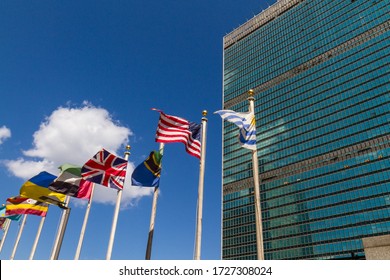 New York City, NY / USA - July 7 2010: United Nations Building With Flags Of Diverse Nations Waving In Front Of It.