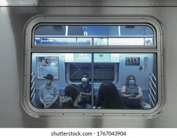 New York City, NY/ USA- 6-29-20: People Wearing Face Mask Taking The New York City Subway Trains