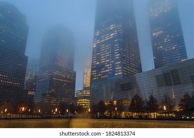 New York City, NY, USA - Dec 29th 2014: Low Angle View Of Manhattan Freedom Tower And Other Skyscrapers On A Foggy Night In New York. Buildings Fading Into The Fog