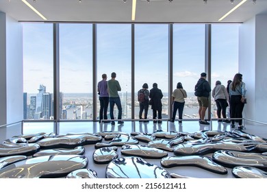 New York City, NY, USA-May 2022; Interior View Of People In Front Of Window Of Exhibition Room With Art Installation Of Summit One Vanderbilt With View On The City And Hudson River