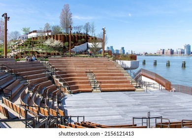 New York City, NY, USA-May 2022; High Angle View Of The Amphitheater Of Little Island Public Park Located In Hudson River Park Designed By Thomas Heatherwick With Freedom Tower In Back