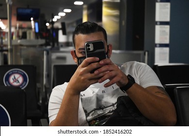 New York City, NY/US- 10/7/2020: A Group Of Passengers Traveling Together Adhere To CDC Guidelines Wearing Masks While Waiting For A Flight At JFK Airport.