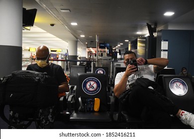 New York City, NY/US- 10/7/2020: A Group Of Passengers Traveling Together Adhere To CDC Guidelines Wearing Masks While Waiting For A Flight At JFK Airport.