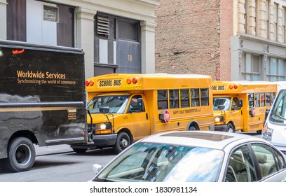 New York City, NY/USA - Dec 30th 2014: Two Yellow School Buses Parked in a Row in a Manhattan Neighborhood