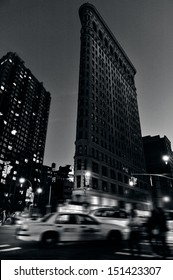 NEW YORK CITY - OCT 14: Traffic Under Flat Iron Building Facade On Oct 14, 2009 In Manhattan New York At Night.It's Considered To Be One Of The First Skyscrapers Ever Built Completed In 1902. (B/W)