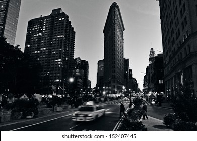 NEW YORK CITY - OCT 14 2009: Traffic Under Flat Iron Fuller Building On Fifth Avenue In Manhattan New York City At Night.It's Considered To Be One Of The First Skyscrapers Ever Built Completed In 1902