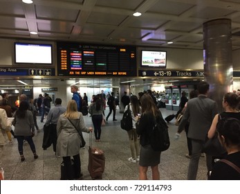 New York City, OCT 2017: Commuters, visitors and travelers look up at the announcement board to see which track their Long Island Railroad train is on.