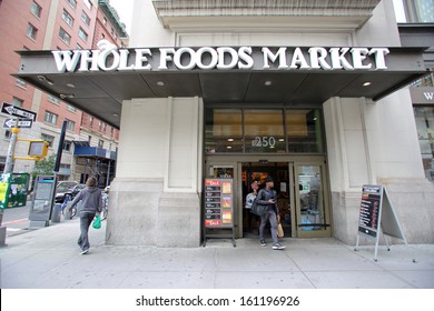 NEW YORK CITY - OCT 23 2013: Shoppers enter a Whole Foods Market supermarket in Manhattan on Wednesday, October 23, 2013. Whole Foods Market, Inc. is an American foods supermarket chain