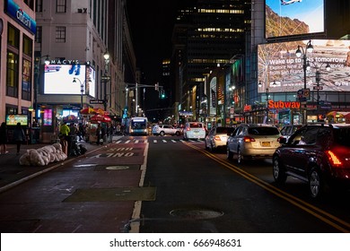 NEW YORK CITY - OCTOBER 01, 2016: Cross Between Fashion Avenue And West 34th Street At Night Time With Lit Up Billboards