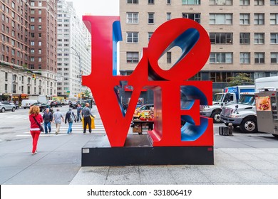 New York City - October 07, 2015: Love sculpture in Midtown Manhattan with unidentified people. It is from artist Robert Indiana, a pop art artist, His media include paper and Cor-ten steel sculpture.