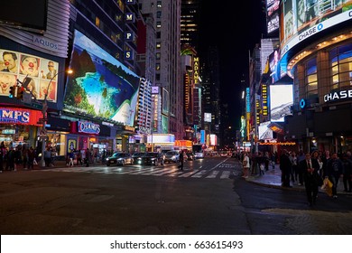 NEW YORK CITY - OCTOBER 07, 2016: Neon Light From Stores And Billboard Signs Reflecting In The Asphalt Of 7th Avenue, At Night Time