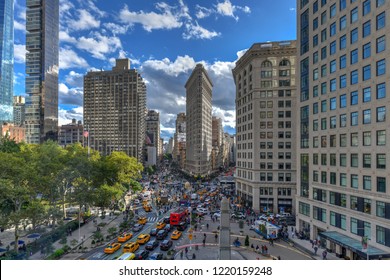 New York City - October 10, 2018: Aerial View Of The Flat Iron Building, One Of The First Skyscrapers Ever Built, With NYC Fifth Avenue And Taxi Cabs.